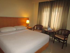 Voodi või voodid majutusasutuse Hotel Wisata toas