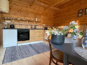 a kitchen with a table with flowers on it at JUST Lodges in Orissaare