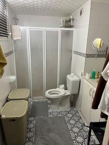 a small bathroom with a toilet and a shower at 250 m walking distance to metro in Burunabat