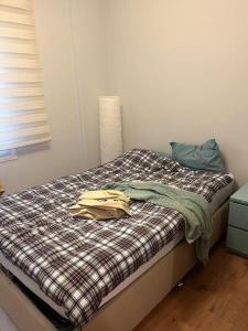 a bedroom with a bed with a shirt on it at 250 m walking distance to metro in Burunabat