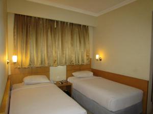 Voodi või voodid majutusasutuse Hotel Wisata toas