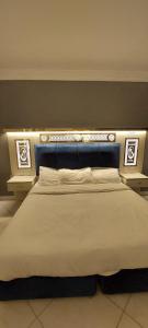 a bedroom with a large bed with two night stands at فندق كلاسيك in Aqaba