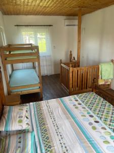 a bedroom with two bunk beds and a window at Leto land Guest House in Pizunda