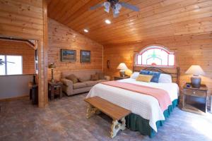 a bedroom with a large bed and a couch at Moss Haven Cabin - Peaceful Blowing Rock Getaway in Blowing Rock