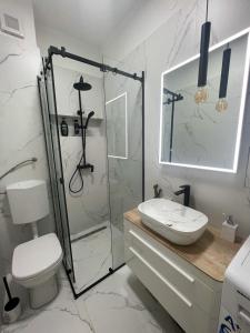 a bathroom with a shower and a toilet and a sink at Serenity Apartment in Zadar