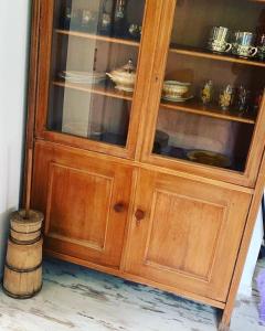 a wooden hutch with glass doors in a room at zaKRZYWEk retro in Cisna