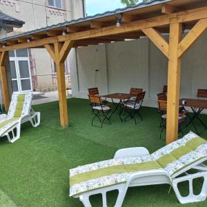 a pavilion with chairs and a table and a table and chairs at Gradina de Vara Sulina in Sulina