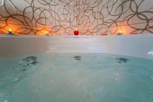 a bathtub with candles in it with at Villa Falcone in Alvignano