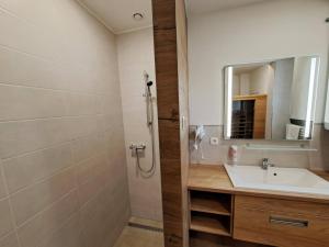 a bathroom with a sink and a mirror at 6bits Apartments in Jeseník