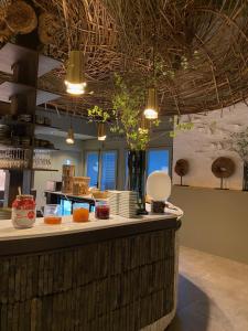 a kitchen with a counter with food on it at Cit'Hotel Le Relais du Boisniard in Chambretaud