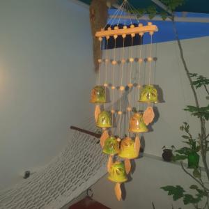 a bunch of bells hanging from a wall at La Maison Radha in Pondicherry