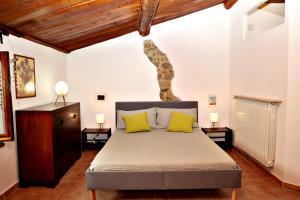 una camera da letto con un grande letto con cuscini gialli di Casa MarJù a Montemassi