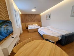 a small room with two beds and a table at 6bits Apartments in Jeseník