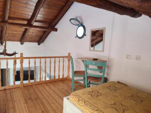a bedroom with a bed and a table and a chair at Skiathos island house in Skiathos