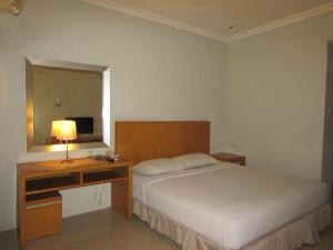 Voodi või voodid majutusasutuse Hotel Wisata toas