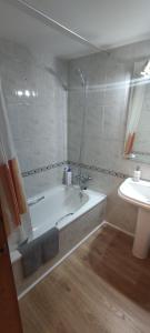 a bathroom with a bath tub and a sink at Apartamento en Benasque in Benasque