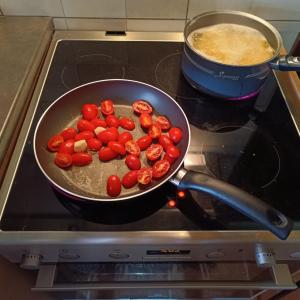 a pan on a stove with tomatoes in it at Αναστασία 