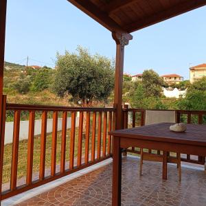 a porch with a table and a view of a field at Αναστασία 