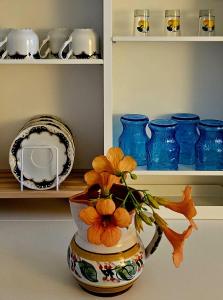 a vase with flowers in it sitting on a counter at Small House Postup in Orebić