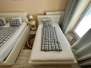 two beds sitting next to each other in a room at Princess City Centre Apartment in Poprad