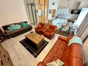 a living room with a couch and chairs and a table at Princess City Centre Apartment in Poprad