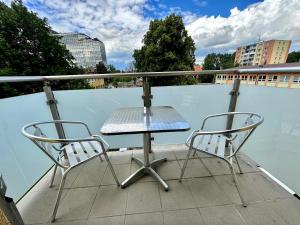 a table and two chairs on a balcony at Princess City Centre Apartment in Poprad