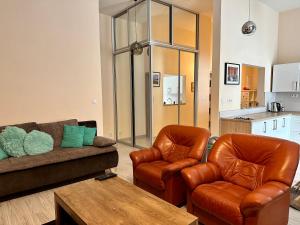 a living room with a couch and two chairs at Princess City Centre Apartment in Poprad