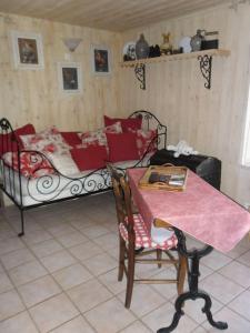 a room with a table and a bed with a table and chairs at GITE LA FERMETTE A DOCELLES in Docelles