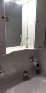 a bathroom with a sink with a mirror and a cabinet at Spata Efi's House in Spáta +34 photos