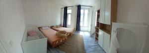 a room with two beds in a room with a hallway at Grand appartement au coeur de Strasbourg in Strasbourg