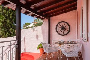 a patio with a table and chairs on a balcony at Casa Frangipani by An Island Apart in Santa Cruz +16 photos
