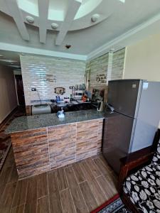 a kitchen with a sink and a refrigerator at Panorama Apartment with a charming sea view near Alexandria and Burg ElArab Airport with Free Wifi شقة باطلالة ساحرة على البحر اول الساحل الشمالي واي فاي مجاني迷人海景公寓 免费无线网络 in Alexandria