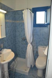 a bathroom with a shower with a toilet and a sink at Villa Bellina in Pefki