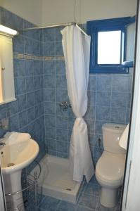 a bathroom with a shower with a toilet and a sink at Villa Bellina in Pefki Rhodes