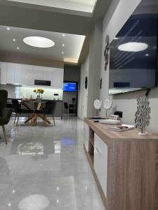 a living room with a kitchen and a dining room at Menda Suite in Heraklio Town