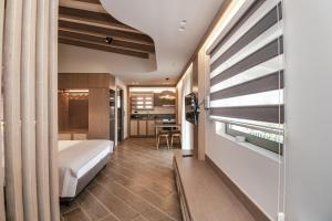 a bedroom with a bed and a desk in a room at Terra Hélios Suites & Studios in Kyparissia