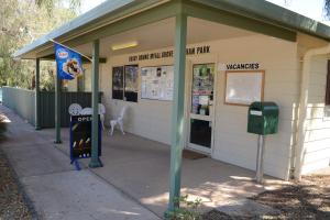 
a person standing outside of a building with a cell phone at Discovery Parks - Roxby Downs in Roxby Downs
