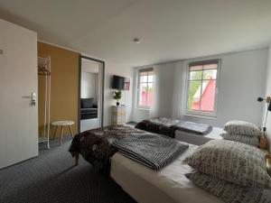 a bedroom with two beds and a mirror at Westhouse in Haapsalu