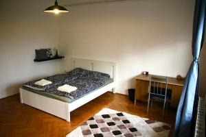 a bedroom with a bed and a desk in it at Castle Stallion in Budapest