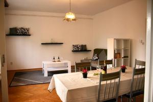 a dining room with a table and a table and chairs at Castle Stallion in Budapest