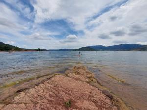 a view of a large body of water with mountains at Mobil-home de vacances in Le Bosc