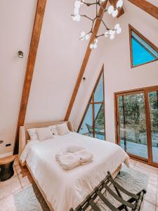 A bed or beds in a room at Tiny Pines A-Frame Cabin, Domes and Luxury Glamping Site