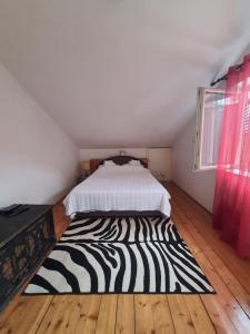 a zebraebra rug on the floor of a bedroom at Apartments Andjus in Sveti Stefan