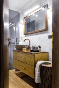 La salle de bains est pourvue d'un lavabo et d'un miroir. dans l'établissement Menda Suite, à Héraklion