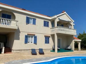 a house with a swimming pool in front of it at Villa Zoe Privlaka-Zadar in Privlaka