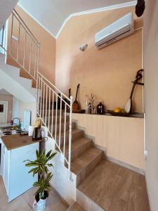 a staircase in a house with a air conditioner at Luštica Old House in Tivat