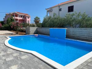 a swimming pool in the backyard of a house at Villa Zoe Privlaka-Zadar in Privlaka