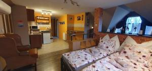 a living room with a bed and a kitchen at Baker Street Apartman in Balatonalmádi +21 photos