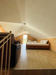 a bedroom with a bed and a wooden floor at Luštica Old House in Tivat