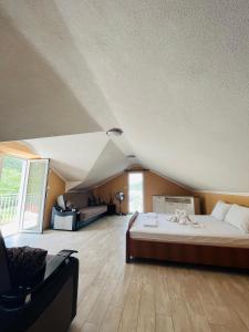 a bedroom with a large bed in a attic at Luštica Old House in Tivat